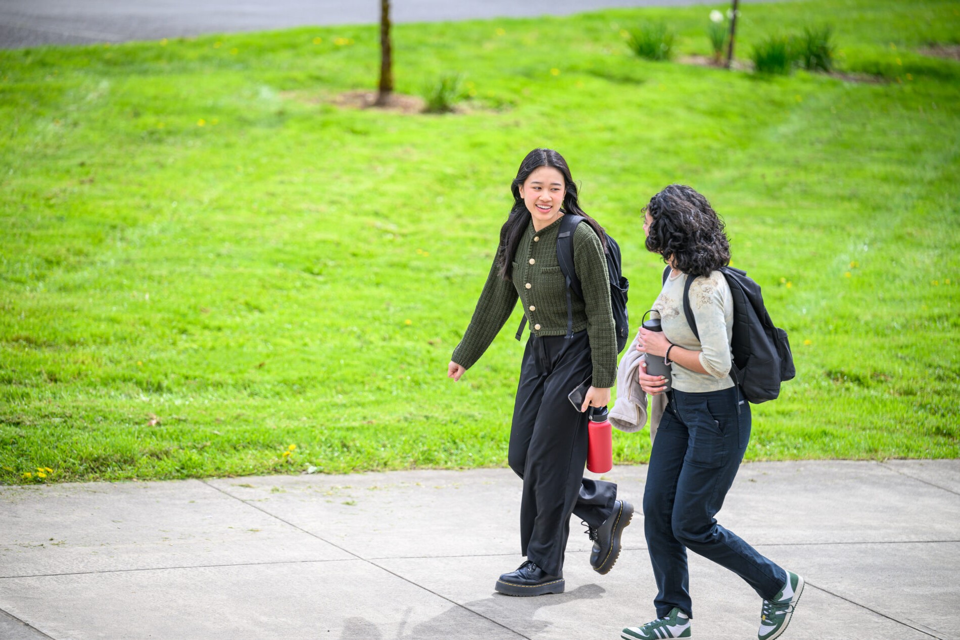 Two students walking on campus.