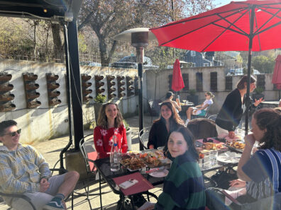 People seated outside at the WGSS Graduation and Awards Celebration.