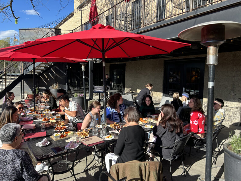 People seated outside at the WGSS Graduation and Awards Celebration.