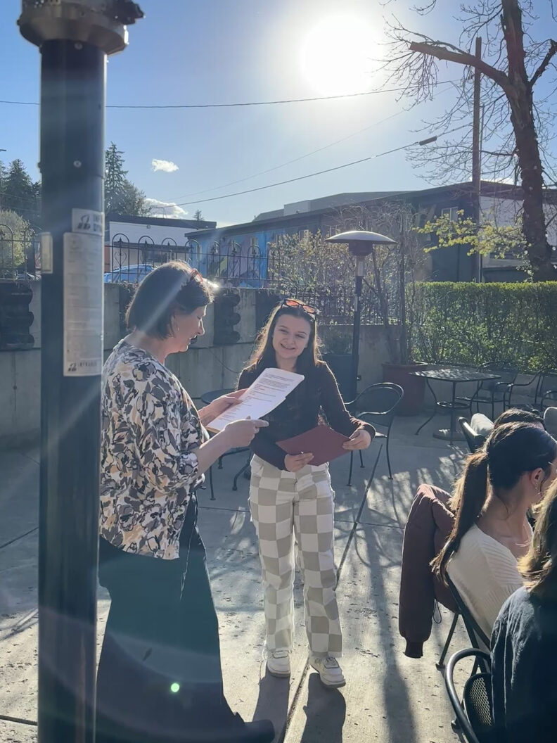 Pam Thoma meeting with students outside.