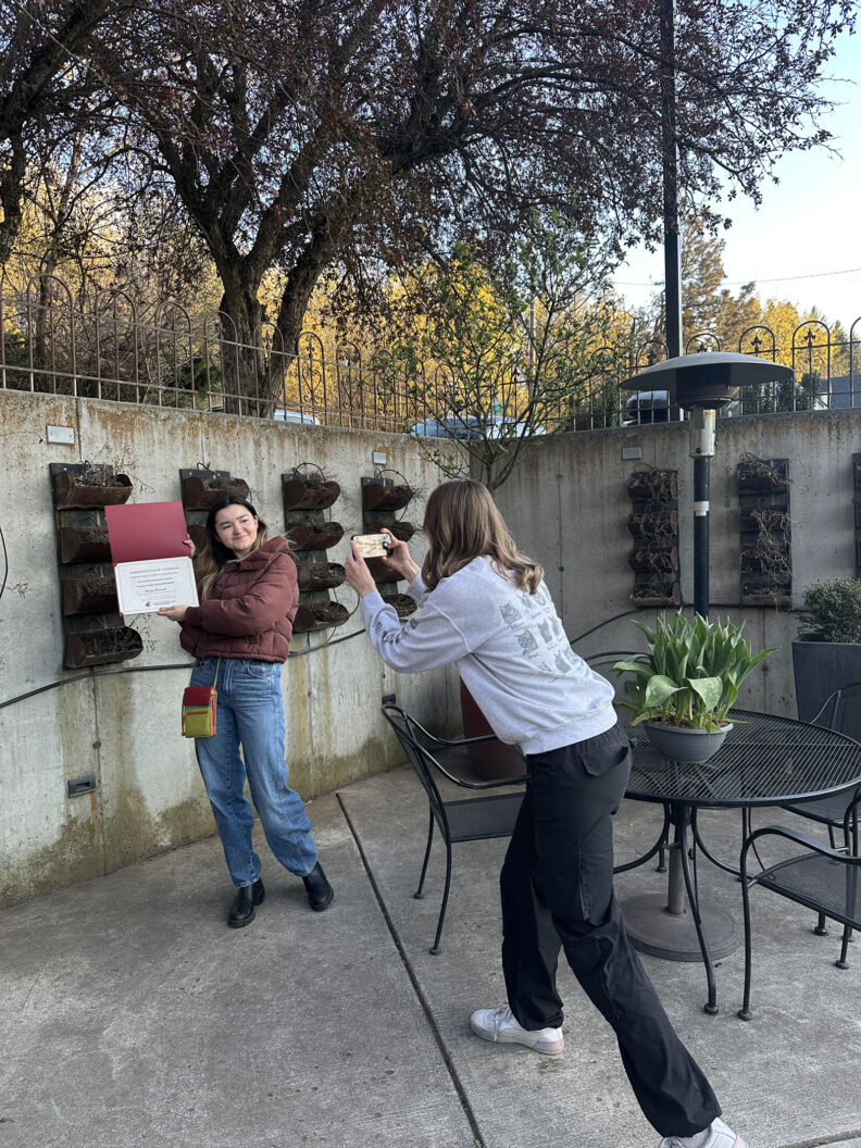 WGSS students taking pictures of their awards.