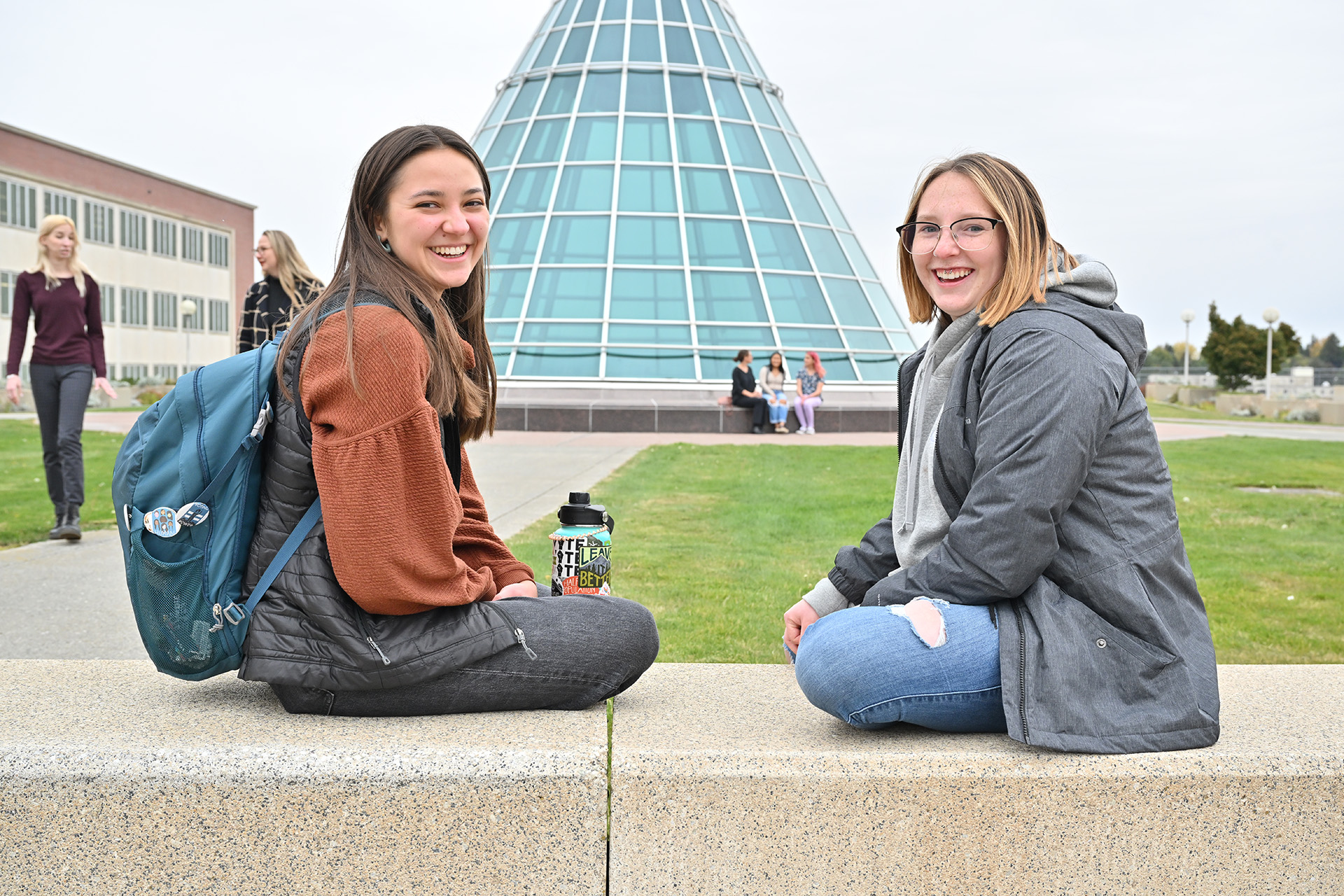 Two students meeting outside in the courtyard above the Holland and Terrell Library.