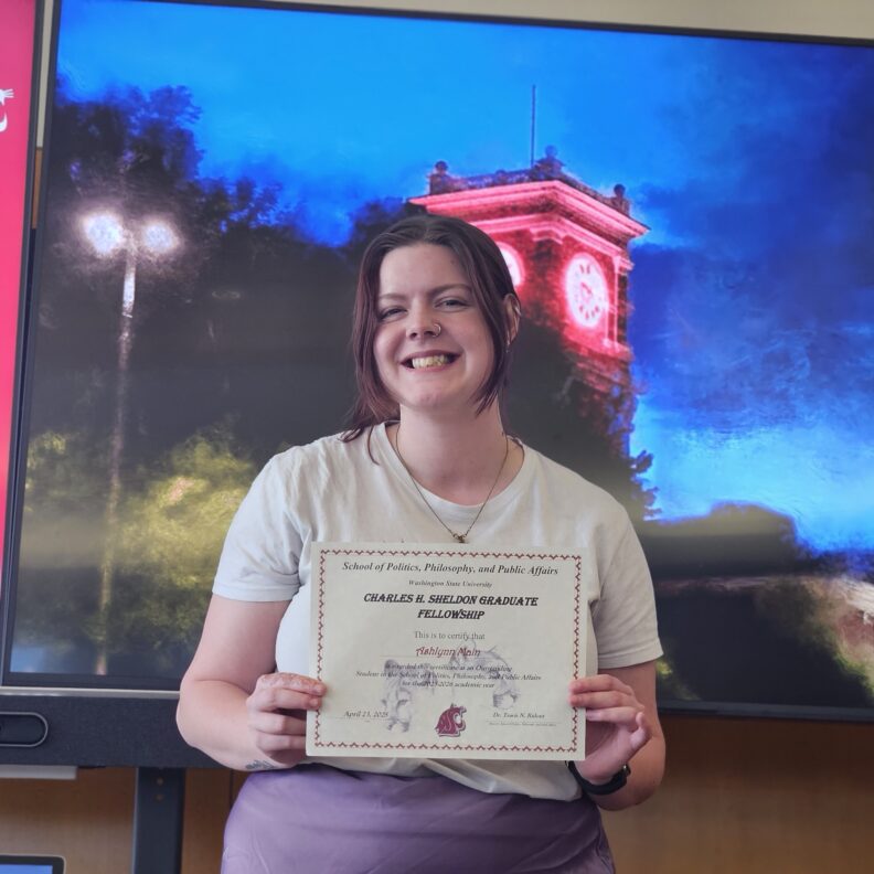 Ashlynn Main holding award.