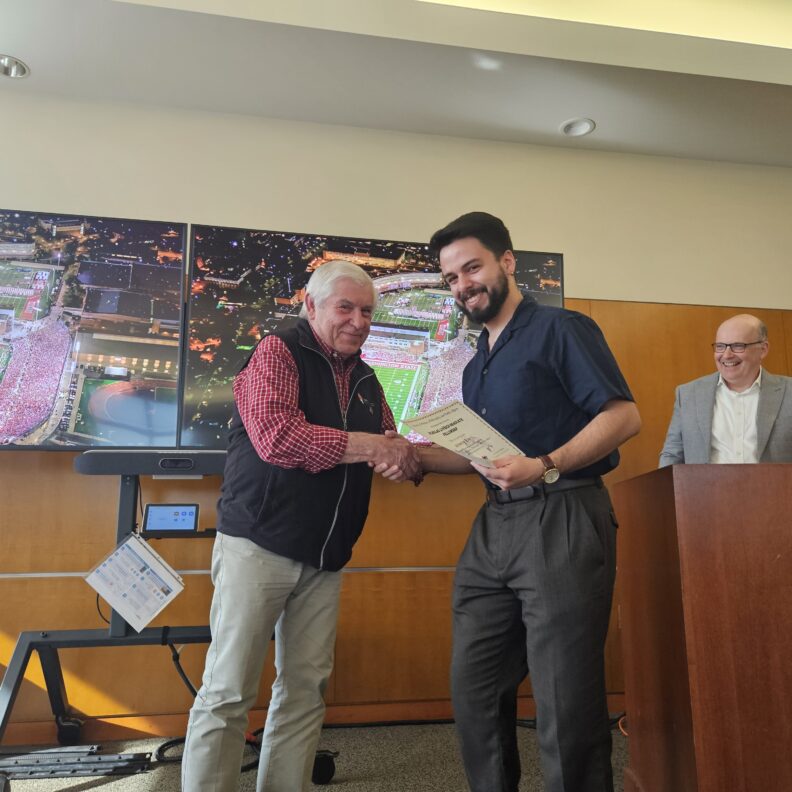 Nicholas Lovrich, Sebastian Ruiz receiving award.