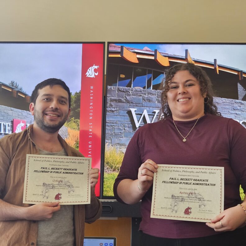 Cj Godkin and Sydney Smith holding awards.
