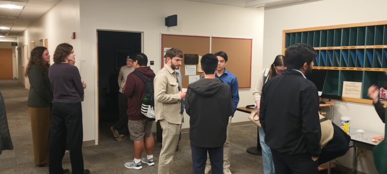 Attendees of RAIN meeting visiting with each other.