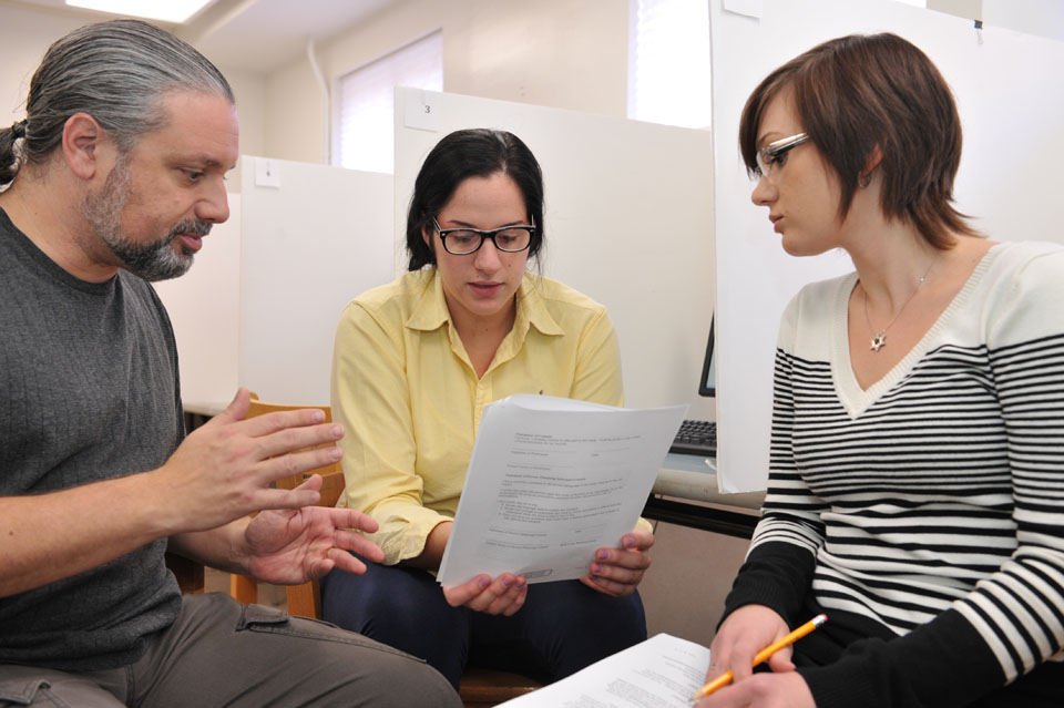 Three people meeting as a group.