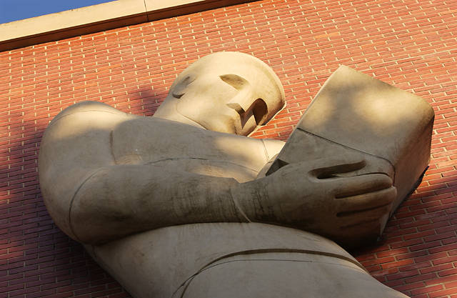 "The Reader" sculpture outside Holland and Terrell Libraries.
