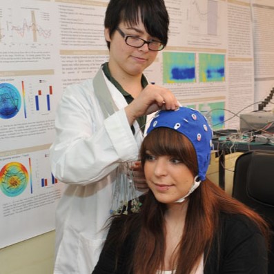 Psychology students demonstrating how to use an electroencephalogram.