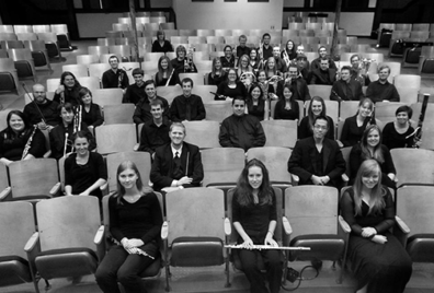 Music students in concert black sitting in auditorium seats. 