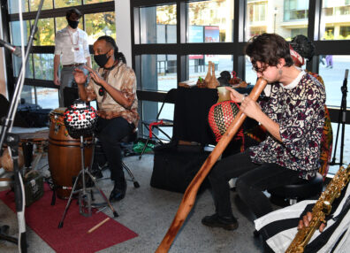 Instrumentalists playing a variety of percussion and wind instruments. 