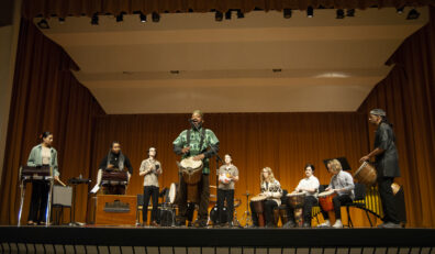 Percussionists on stage with guest artist Samuel Dinkins, III.