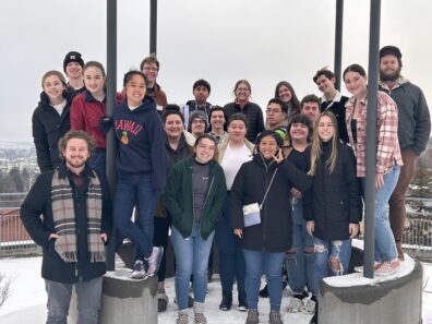 Vocalists outdoors in group.