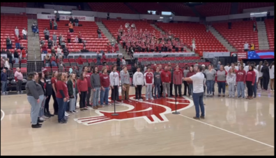University Singers singing at basketball game. 