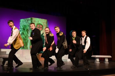 Group of vocalists dancing and singing.