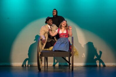 Three vocalists performing.