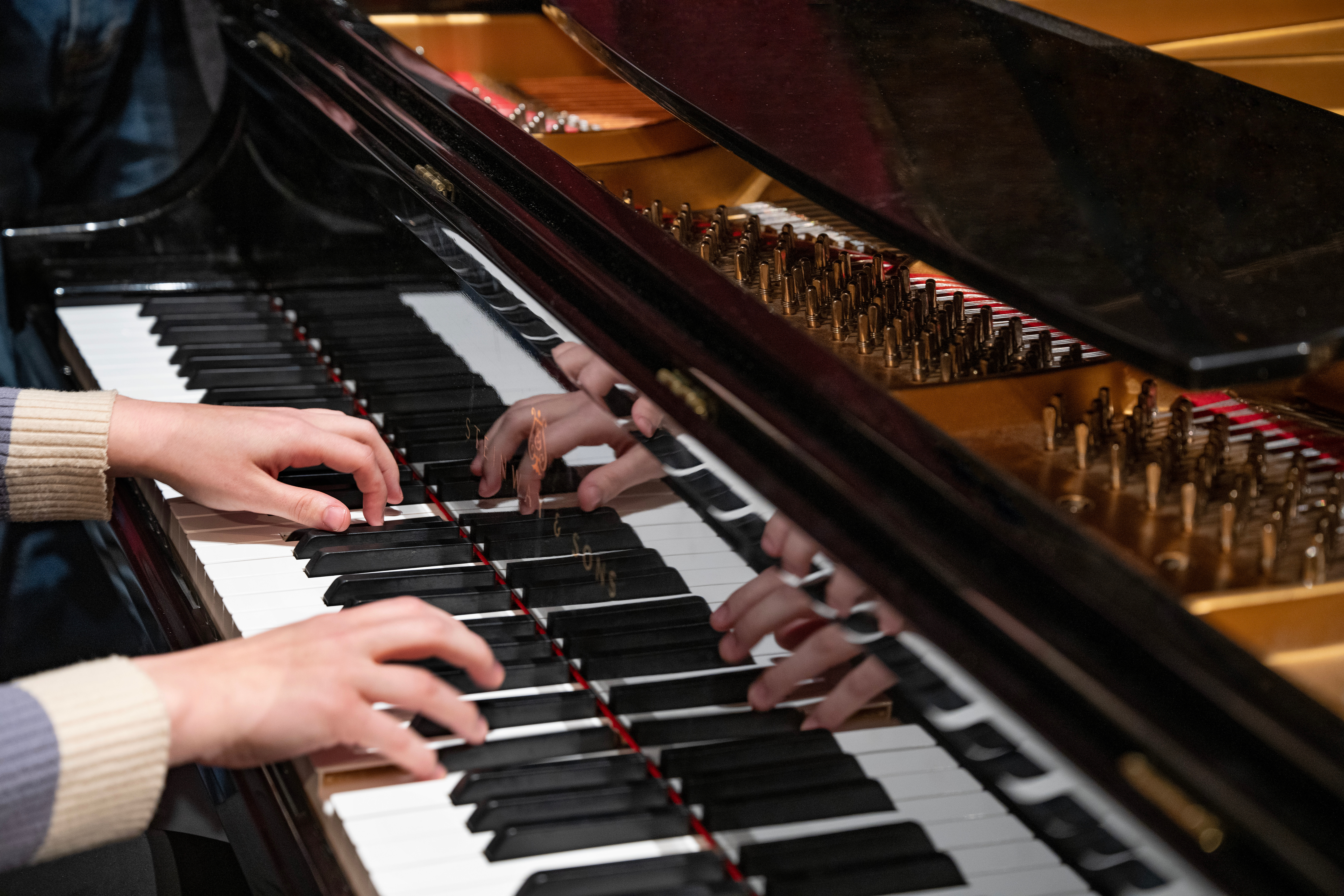 Closeup of hands over a keyboard.