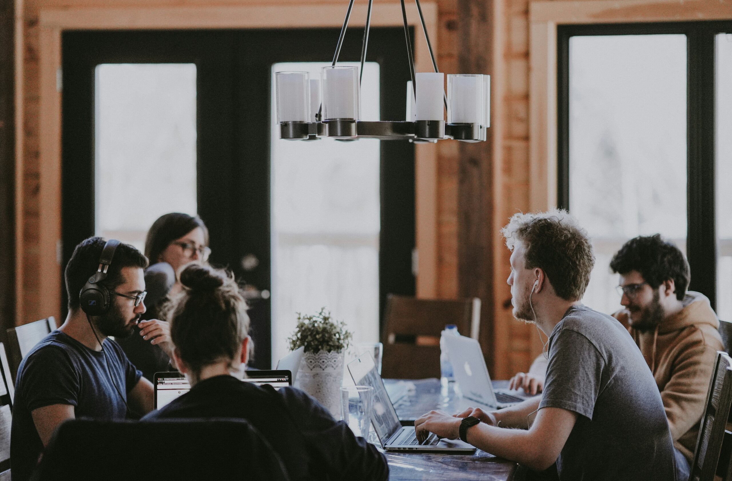 A group of people meet around a table.