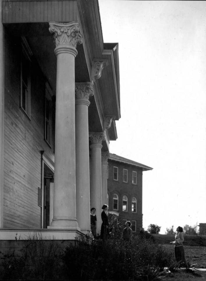Five women standing in front of large building with four large columns