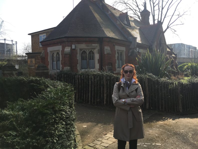 Melanie-Angela Neuilly standing in front of a building.