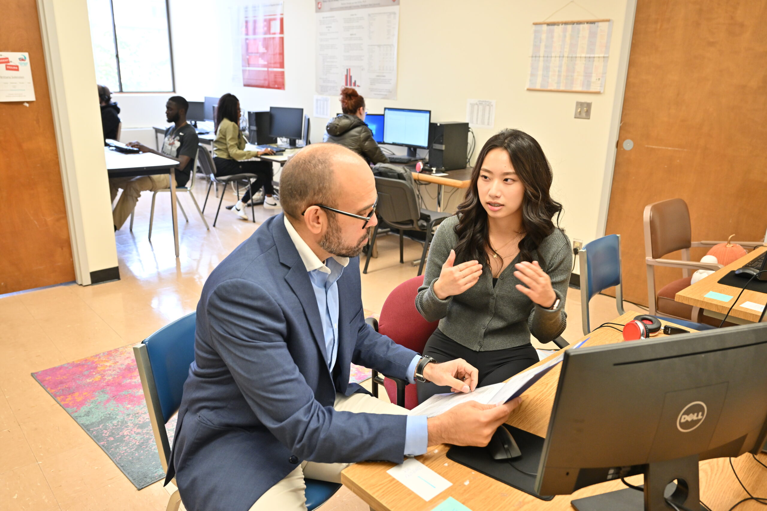 Professor David Makin discussing research with a student.