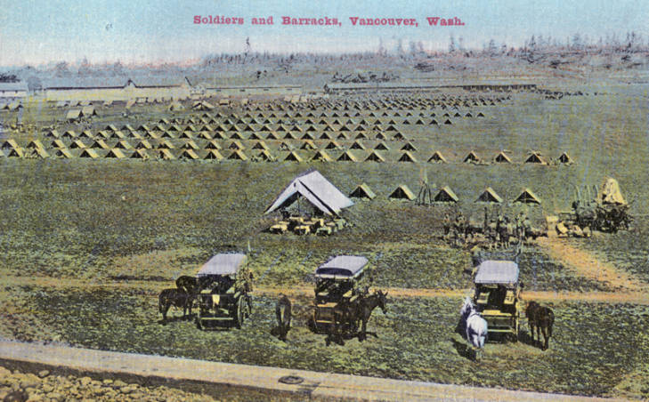 Historic photograph of soldiers and barracks in a large open field, with wagons and horses in the foreground.
