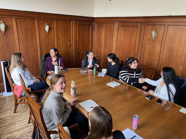 Group meeting at a table in a conference room.