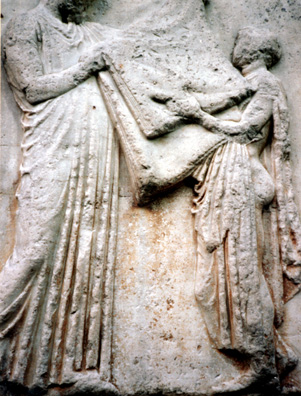 ELGIN MARBLES: Better to keep them at home, folding the laundry. Just kidding--this scene depicts the folding of the ritual garment annually carried to clothe the statue of Athena in the Parthenon.