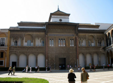 SEVILLA: Paula Elliot and guide approach the entrance to Seville's Royal Palace, built on Moorish ruins by Pedro 1 (1350-1369).
