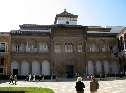 SEVILLA: Paula Elliot and guide approach the entrance to Seville's Royal Palace, built on Moorish ruins by Pedro 1 (1350-1369).