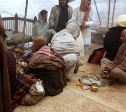 This Brahmin priest takes the ashes brought to him by bereaved survivors and kneads them into balls with Ganges water which are then thrown into the river, bringing merit to the deceased spirit comparable to that of being cremated on the "burning ghats" themselves. Shot on a chilly, foggy winter morning.