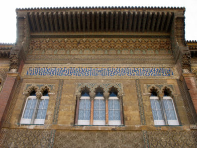 SEVILLA: The highly stylized Kufic calligraphy in blue and white reads "There is no conqueror but Allah." It is surrounded with a Spanish inscription praising the builder of the main part of the Alczar, the Christian Pedro I.