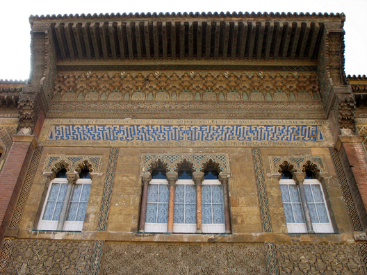 SEVILLA: The highly stylized Kufic calligraphy in blue and white reads "There is no conqueror but Allah." It is surrounded with a Spanish inscription praising the builder of the main part of the Alczar, the Christian Pedro I.