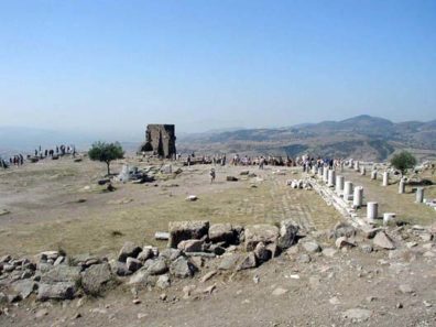 PERGAMUM ACEOPOLIS: The most famous building in ancient Pergamon/Pergamum was its library. So many distinguished scholars gathered here that the Egyptian scholars in charge of the great library at Alexandria feared a "brain drain" and decreed a ban on papyrus exports to Pergamum. The scholars here devised a method of writing on animal skins that spread throughout Europe and became known as "parchment"--meaning "from Pergamum." Not much is left of the library today.