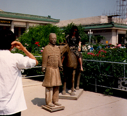 FIRST EMPEROR'S TOMB: May 22: We visited the First Emperor's tomb--or rather, the outlying excavations where the "soldiers and horses" have been dug up. No pictures allowed inside, but tourists pose on models outside.