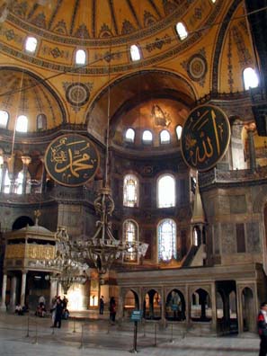 HAGIA SOPHIA: In 1935 Ataturk converted the church into a museum and work has continued for decades to restore the interior decoration. Many of the church's riches had been carried off by the Venetians in the infamous Fourth Crusade, and the mosaics and paintings offensive to Muslim belief were plastered over. The Venetians still keep their spoils, but the Turks have largely restored the covered decorations. The large round shields are part of the Muslim history of the building, bearing Arabic inscriptions with the names of God, Muhammad, and other important figures in the early history of Islam. The structures below also date from the Ottoman era.