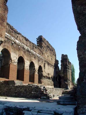 RED BASILICA: Side view of large arches highlighted by the sun.