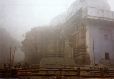 It was too misty to get a clear shot of the Golden Temple of Shiva. It lies immediately adjacent to this mosque, built on the ruins (and actually incorporating parts of) an earlier Hindu temple, and which Hindu extremists wanted to tear down. The wooden barriers in the foreground had been erected by the soldiers (seen to the left) sent to guard the site of this Muslim mosque in the most Hindu of cities. They did so effectively, we heard, keeping the two crowds of worshipers from tearing each other apart this time. This mosque is immediately adjacent to one of the most important Hindu temples in Varanasi, the most Hindu of Indian cities. Armed guards with machine guns were standing watch against the possibility of interreligious conflict at the site; the Ayodhya riots had taken place not long before. The Mughal pattern of destroying Hindu temples explains why there are relatively few really old ones in North India, where their influence was greatest. It would be wonderful to go elsewhere to experience traditional Hindu architecture, but our tour itinerary didn't allow us to see much of this sort of thing.