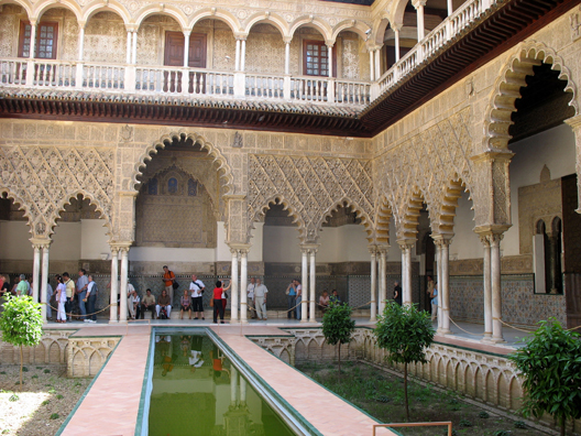 SEVILLA: The heart of the 14th C. Palace of Pedro I is this Mudejar courtyard. Recent excavations had shown that it once hand a pool like this so it has now been reconstructed. The upper balcony was added by Carlos V in classic Renaissance style.