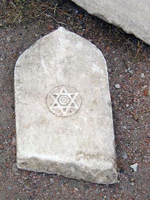 White stone tablet with star of David etched into center.