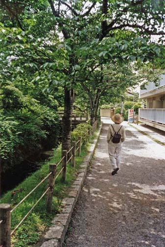 This famous walk parallels a pleasant little canal along a street lined with fine houses and several important Buddhist temples. Tourist Paula Elliot walks along the path. May 26, 1998