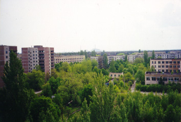 Sasha's former school is the two-story building on the right; in front of the school there is football field overgrown with young trees. The reactor dimly visible on the horizon. (May, 9, 1999)