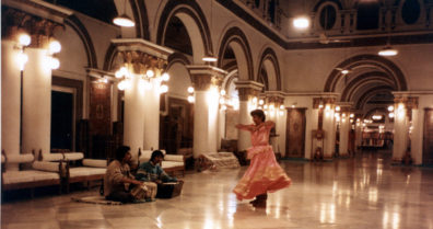 Tabla player, harmonium player, and dancer performing at a Kashmiri Rug emporium in a converted palace.