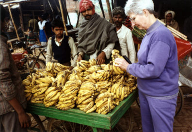 Mary Gallwey buys bananas from a vendor on the road between Varanasi and Calcutta.