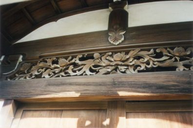 KYOTO: A carved wooden transom. Note the way in which only the underside of eave details is painted white to highlight the structure.
