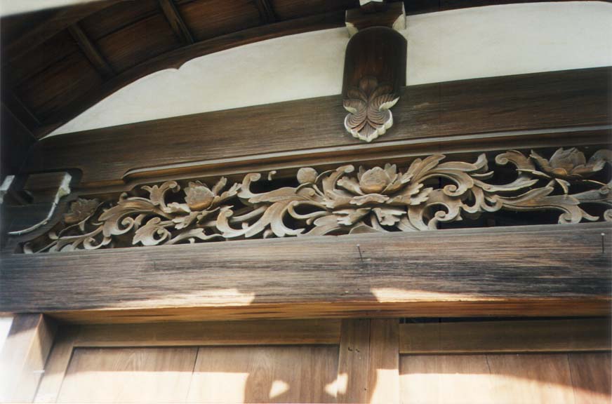KYOTO: A carved wooden transom. Note the way in which only the underside of eave details is painted white to highlight the structure.