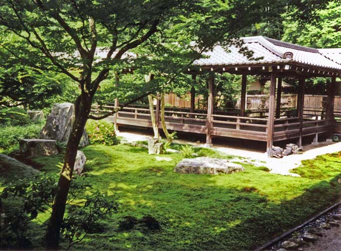 KYOTO: View across a moss garden from one wing of the temple to another. Like other temples, this was originally built as a villa, for the retired Emperor Kameyama; but upon his death in 1291 it was converted to religious uses. Emperors used to be required to retire upon the birth of an heir, which kept the imperial family safely weak and led to a large leisured class of reasonably young retirees. The present buildings are a 17th-century reconstruction, the headquarters of the Rinzai school of Zen. May 26, 1998