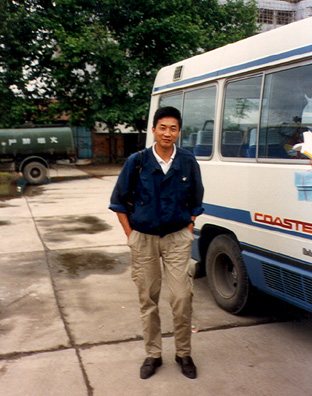 XIAN: Our local guide in Xian, friendly and well-liked. Also quite tall. In front of our bus, one of several uncomfortable (though sometimes air-conditioned) "Coasters" that we did our traveling in.