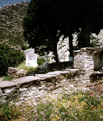 NAXOS: We visited the small church of Agia Anna in the country which had this graveyard attached. Bodies are buried for only a few years, then the bones are disinterred and stored in the church; so all the graves are relatively new. The priest's wife did a thriving business in selling needlework.