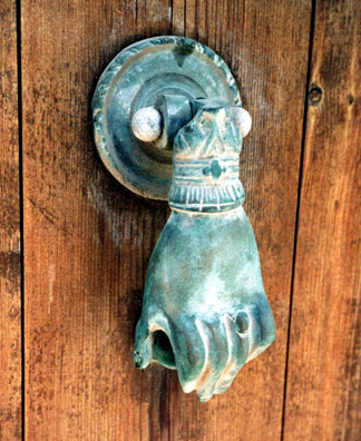 NAXOS: Traditional hand-shaped door knocker.